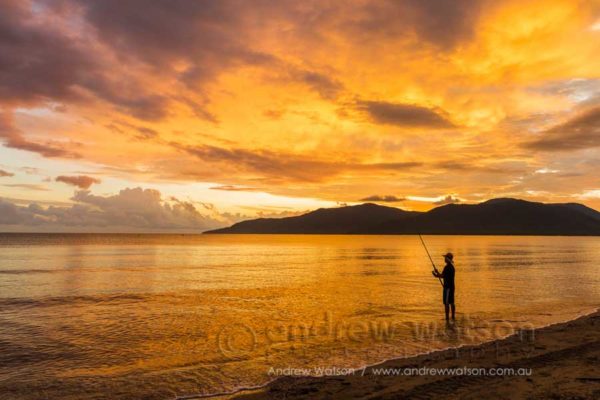Man fishing along Cairns Esplanade at sunrise