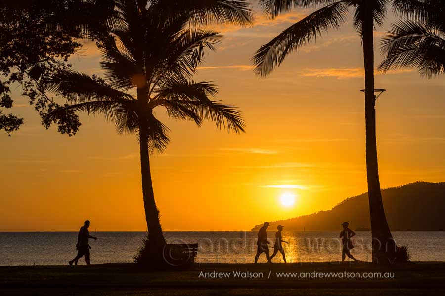Walkers along the Cairns Esplanade at dawn