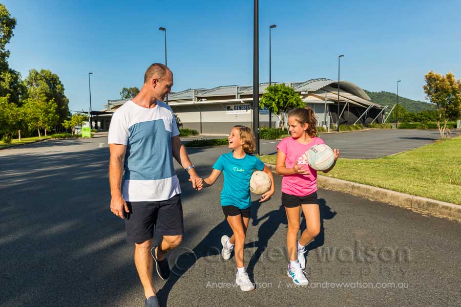 Lifestyle image of a father and kids outside sports centre