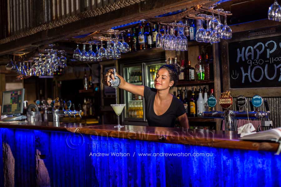 Waitress pouring a cocktail at the Iron Bar, Port Douglas