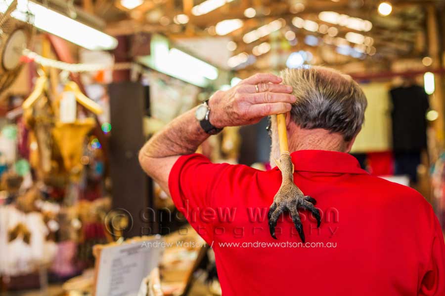 Man using kangaroo back scratcher at the Kangaroo Shop in the Heritage Markets, Kuranda