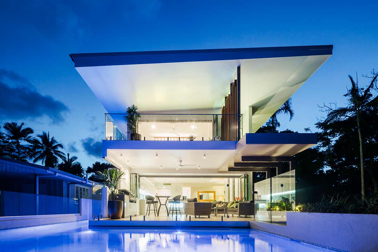 Twilight image of architectural designed residence showing pool and two storeys