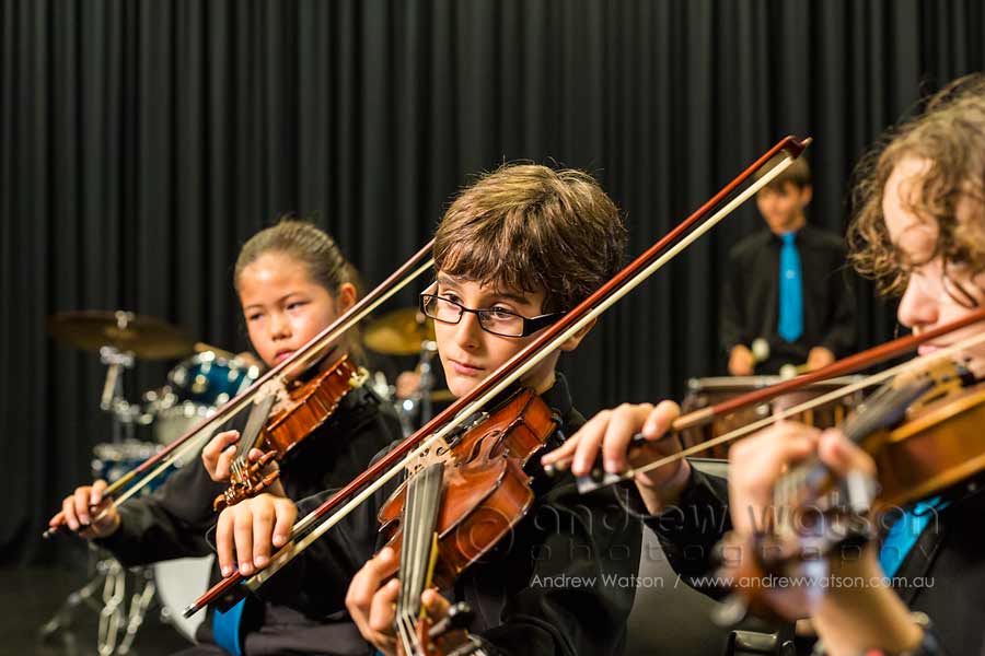 Image of school students playing instruments in string ensemble