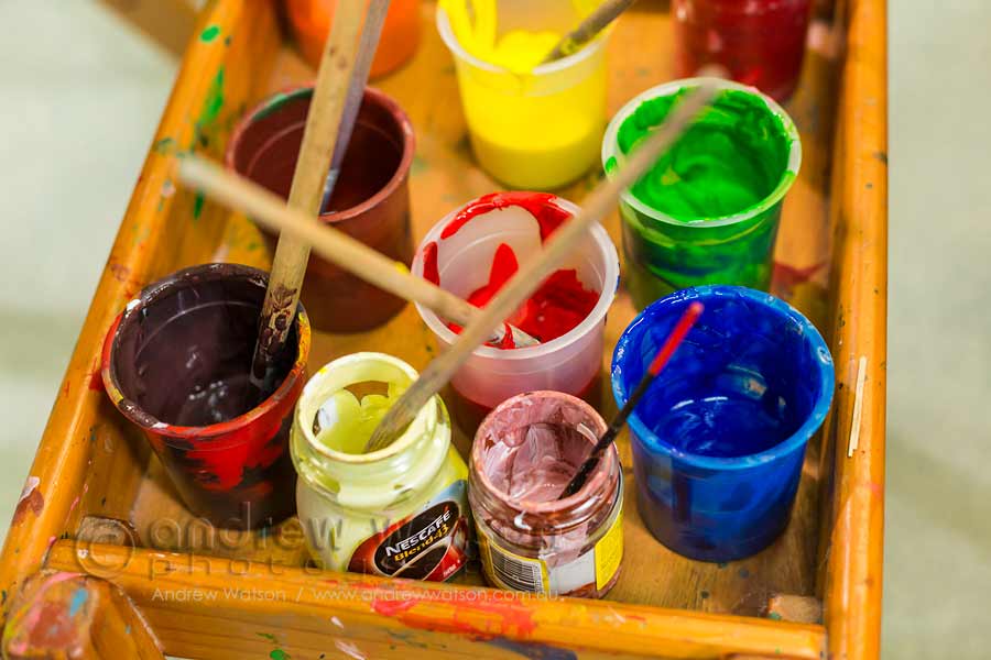Image of paint brushes and pots in school art