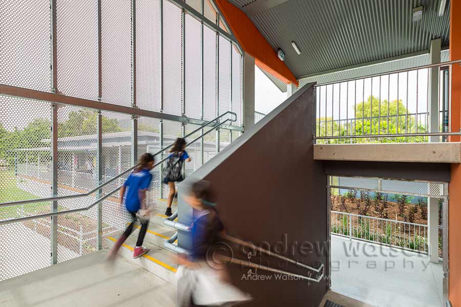 Image of school children running up staircase