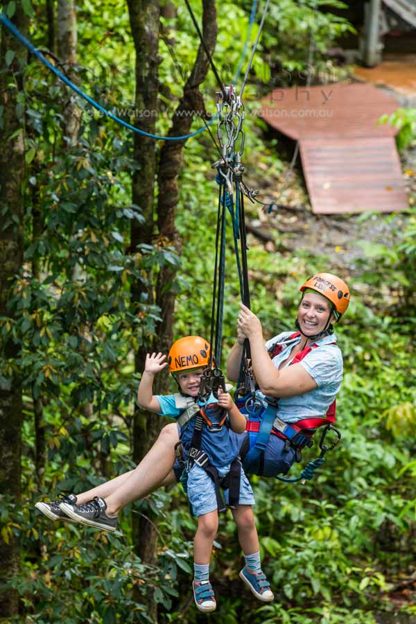 Image of mother and young child on rainforest zipline in Daintree