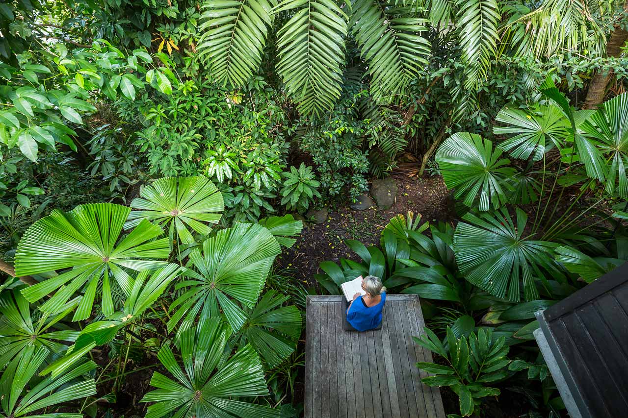 Image of woman relaxing in residential tropical garden in Port Douglas