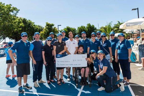 Image of Dylan Alcott presenting charity cheque in Cairns