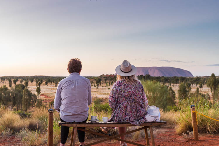 Image of visitors watching the sunrise at Uluru