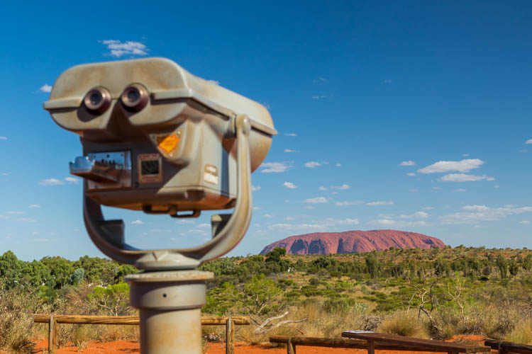 Image of binoculars and Uluru beyond