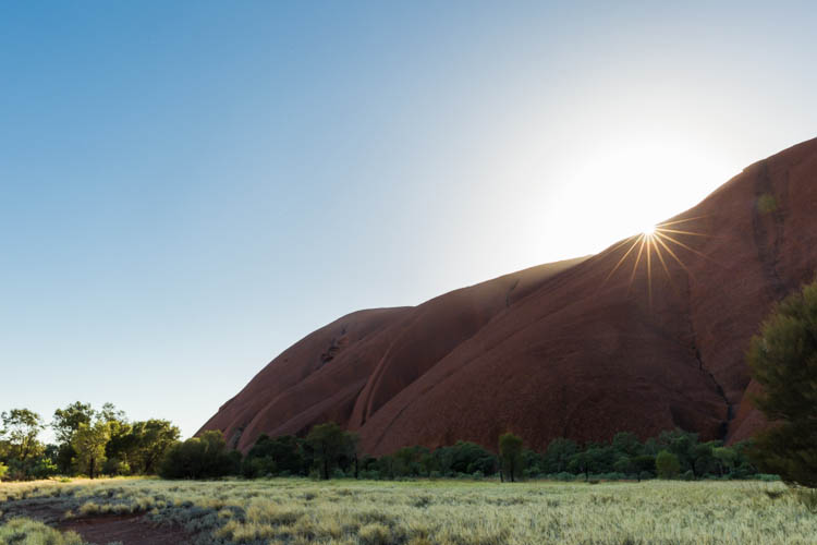 Image of the sun rising above the slopes of Uluru