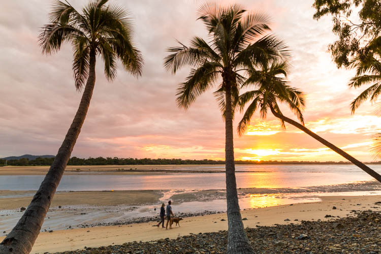 Image of couple walking along beach at sunset in Eimeo, Mackay