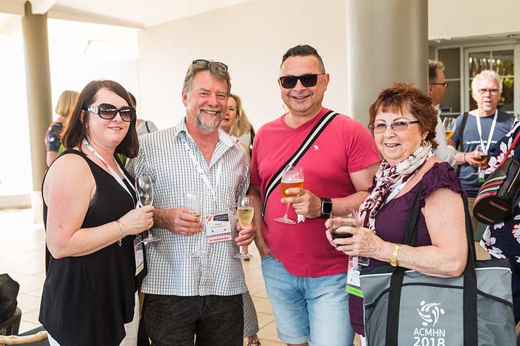 Group of conference delegates enjoying a drink at a networking function