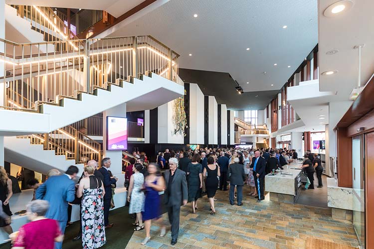 People gather inside the foyer of the Cairns Performing Arts Centre for opening night