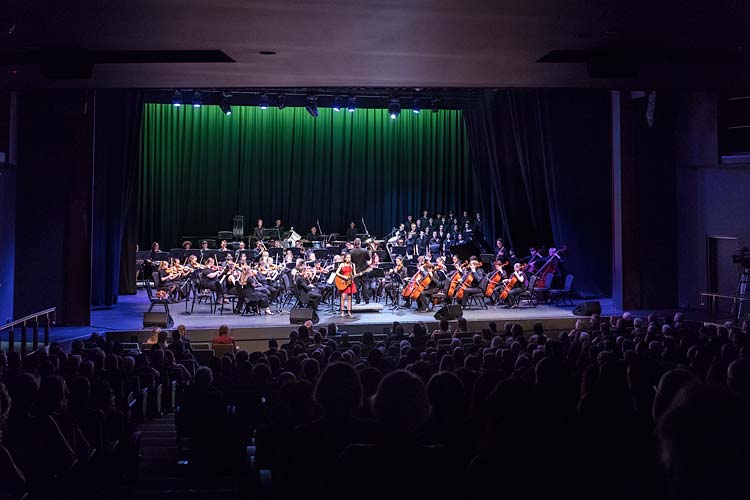 Singer and orchestra on stage during performance at the Cairns Performing Arts Centre