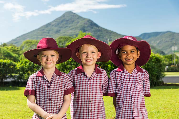 Group of smiling young school kids in uniform