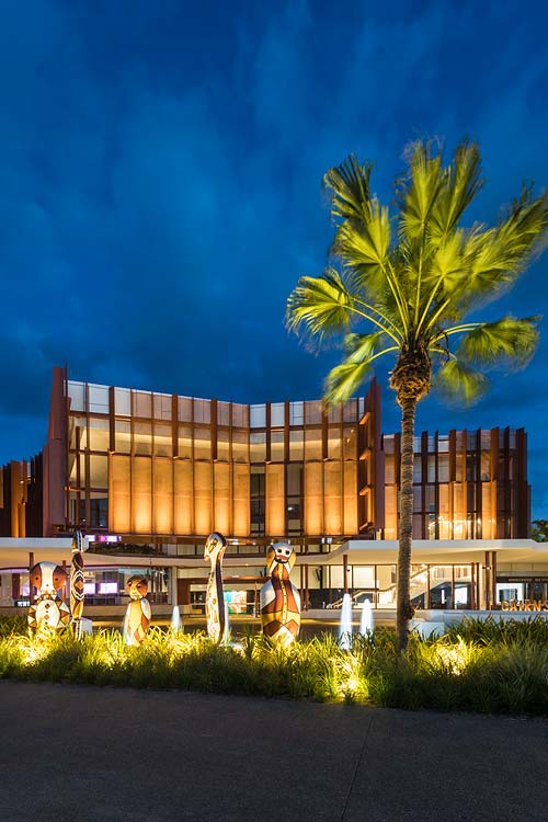 Exterior view of the Cairns Performing Arts Centre indigenous scultpures and facade at twilight