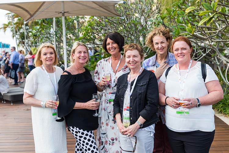 Group of conference delegates enjoying a drink at a networking function