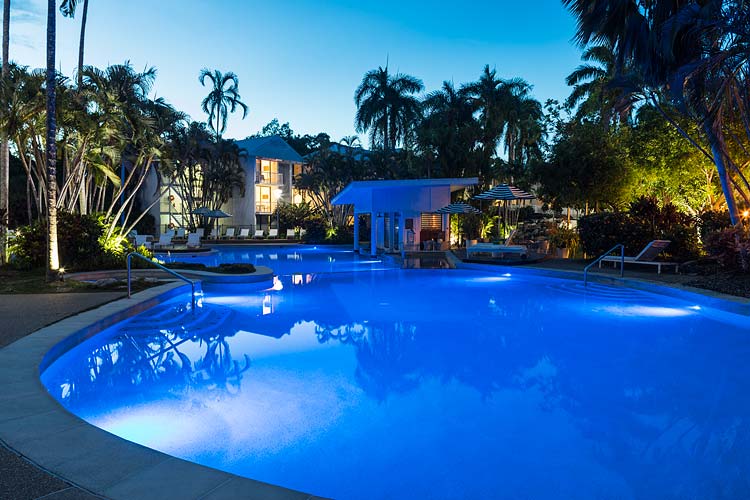 Resort pool lit at twilight, Port Douglas