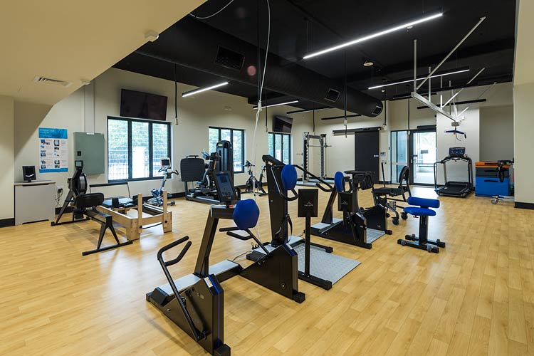 Gym room filled with exercise machines for spinal rehabilitation