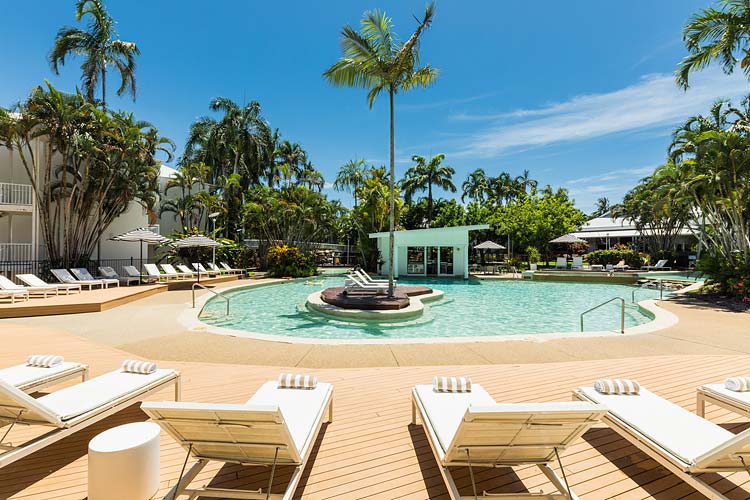 Sun lounges around a lagoon style pool at a Port Douglas resort