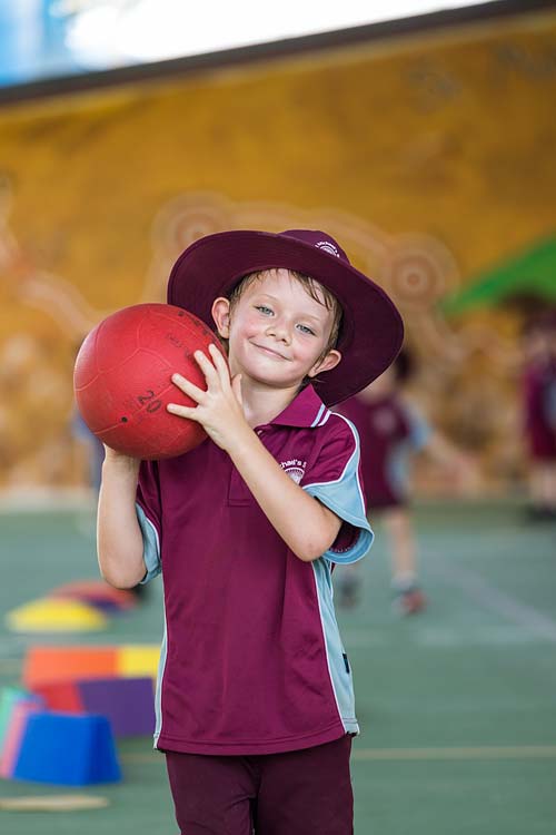 Portrait of young school student holding sports ball