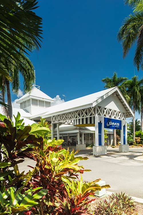 View through foliage to resort facade in Port Douglas