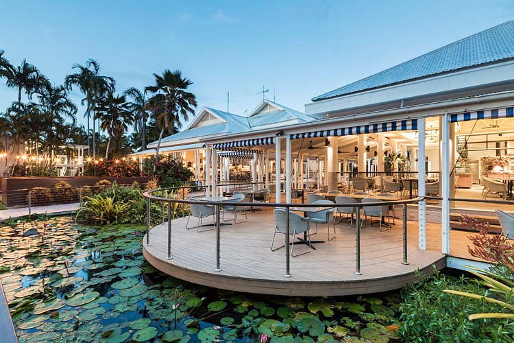 Exterior of resort restaurant surrounded by lily pond