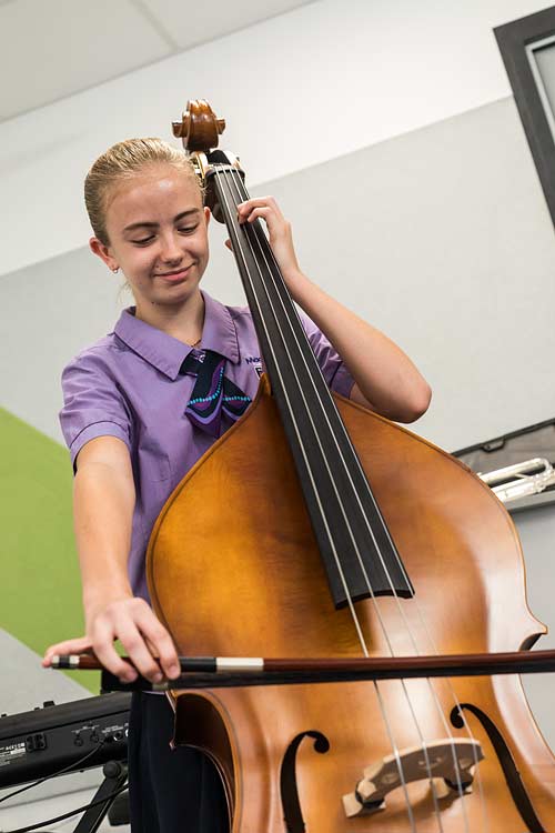 Female school student playing the cello