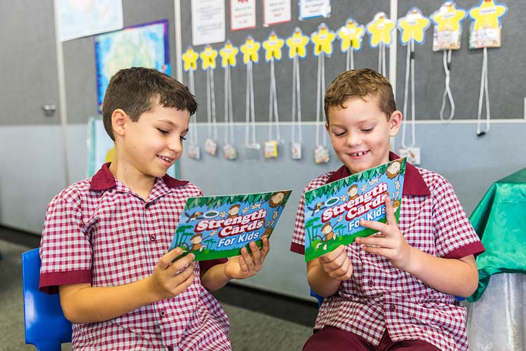 Two students playing with educational cards in the classroom