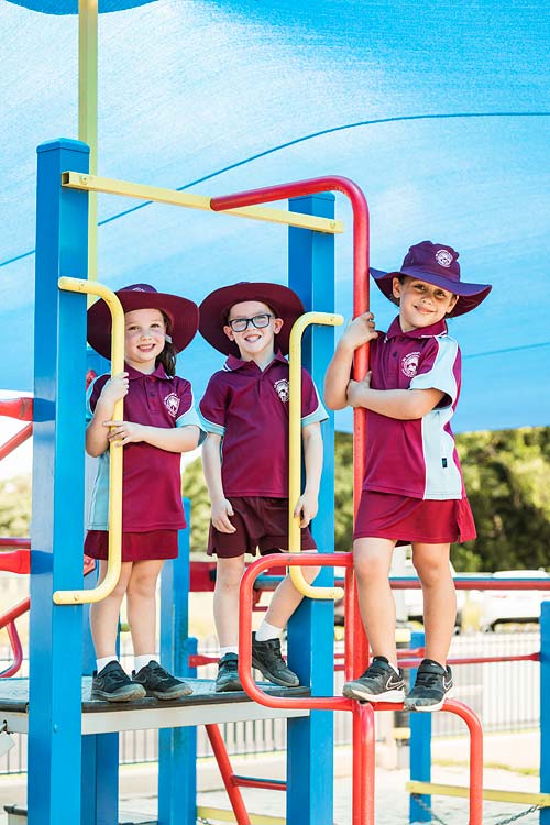 Portrait of young school students on the playground equipment