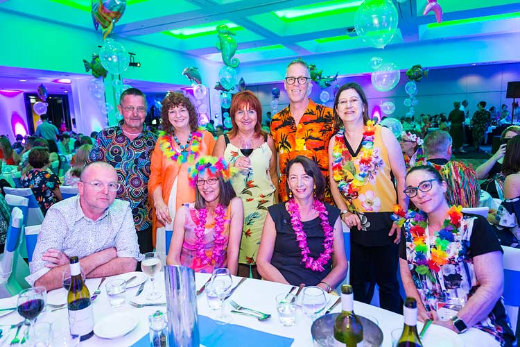 Group of delegates in tropical dress at conference dinner