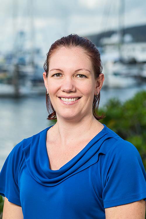 Corporate headshot of a female accountant with harbour background