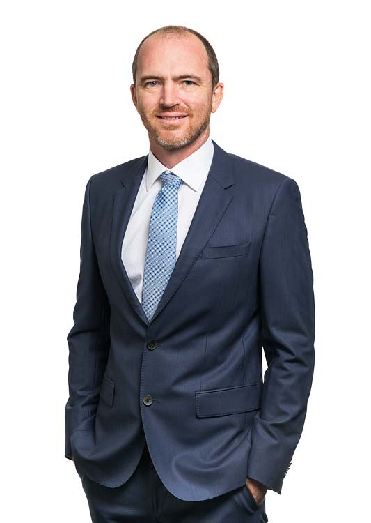 Corporate portrait of a male commercial property services agent with white background