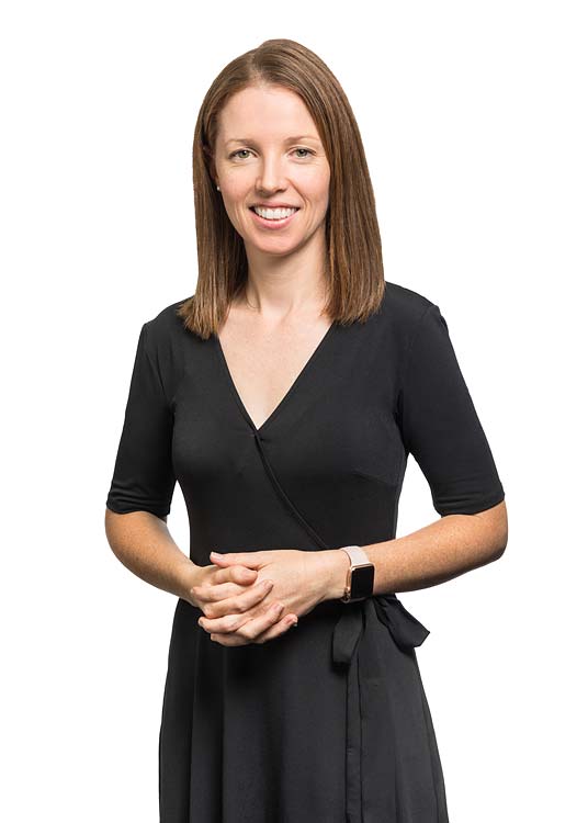 Corporate portrait of a female commercial property valuer with white background