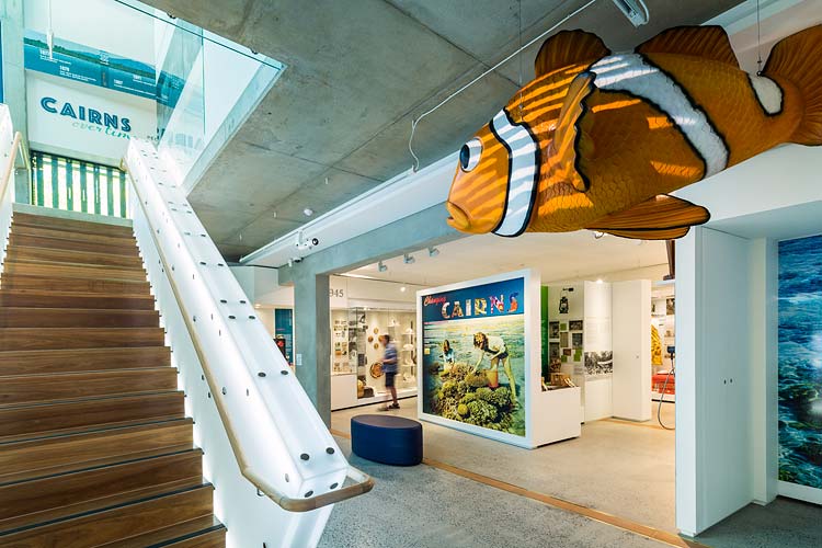 Interior of the Cairns Museum showing a visitor viewing the Changing Cairns exhibition