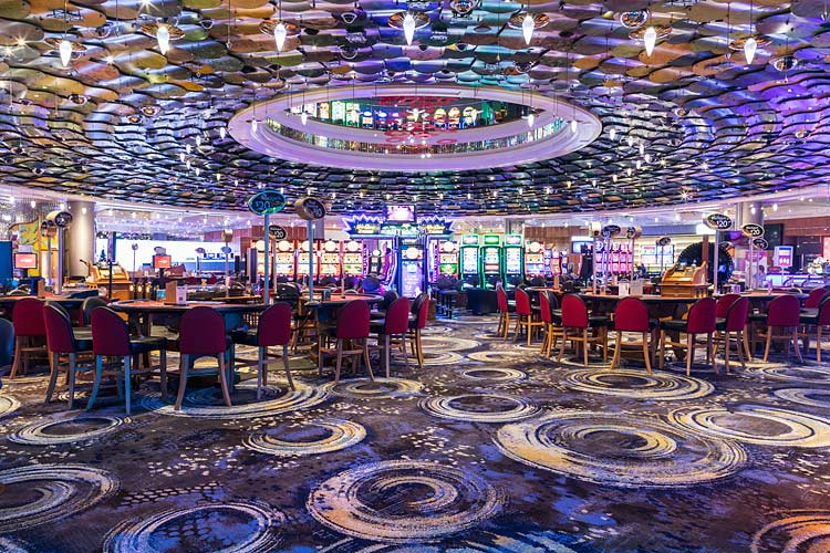 Interior of the Reef Hotel Casino showing the gaming floor and tables
