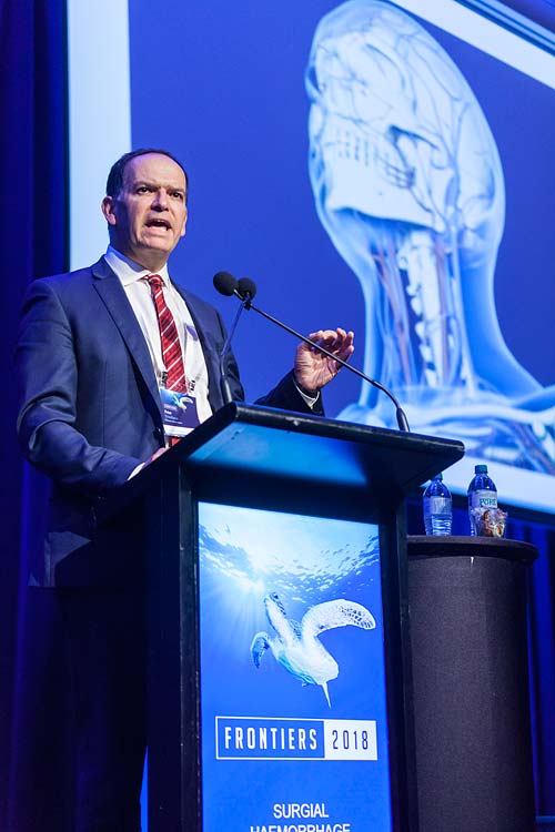 Speaker at podium at medical conference in Cairns
