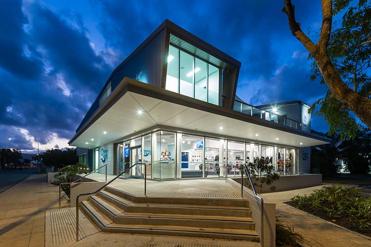 Exterior of the Quicksilver Dive Centre showing the retail and training levels at twilight