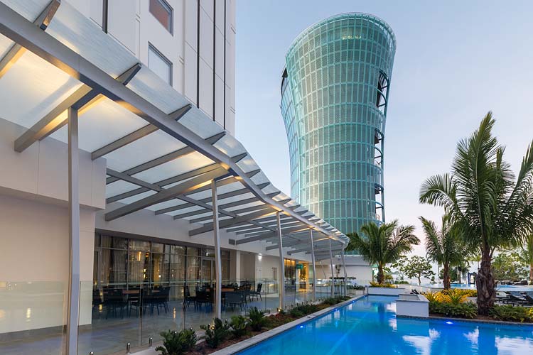 Exterior of the Hotel Riley showing glass panel roofing around the hotel pool