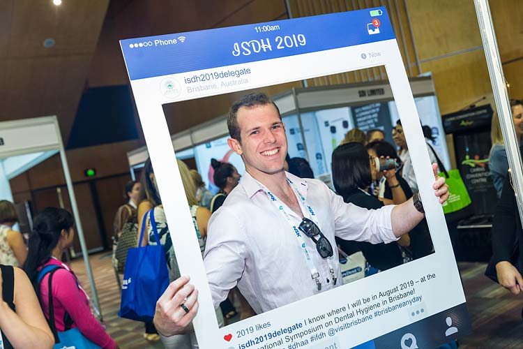Conference delegate holding Instagram frame