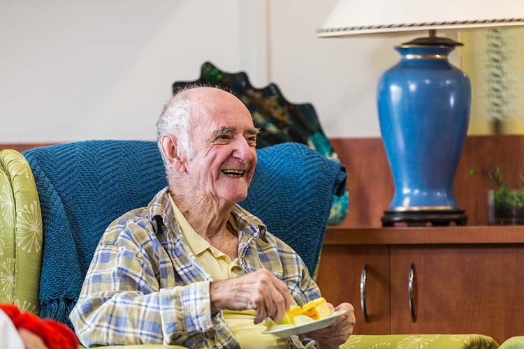 Portrait of a male resident enjoying morning tea at an aged care home