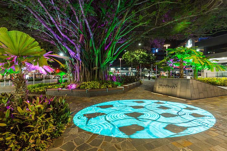 Indigenous artwork digitally projected on walkway and illuminated trees in the Shields Street Heart Project, Cairns