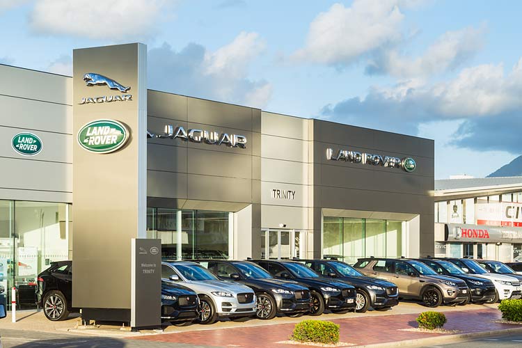 Exterior of the Trinity Jaguar car dealership showing facade and cars for sale