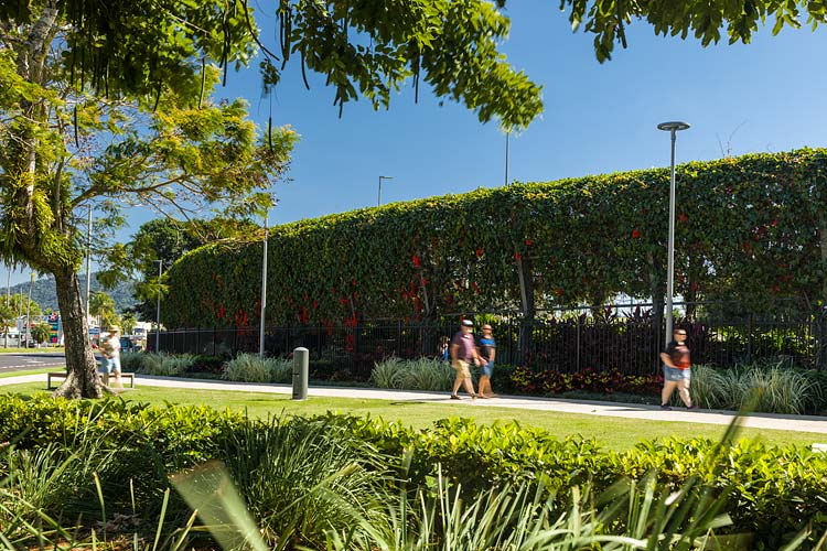Visitors walking past the exterior of the vine covered arbour walkway at the Munro Martin Parklands