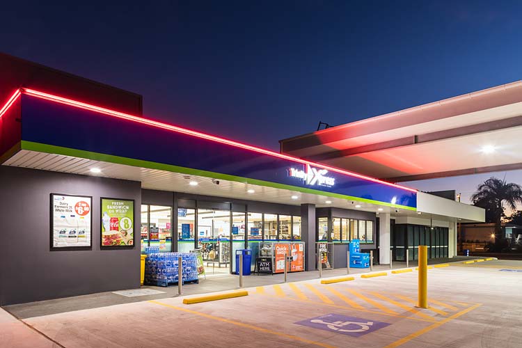 Exterior of Mobil service station convenience store illuminated at twilight