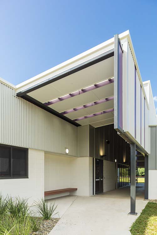 Exterior of new school building with angled roofline over entrance