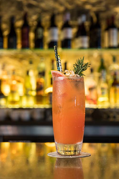 A colourful tropical cocktail on a bar top