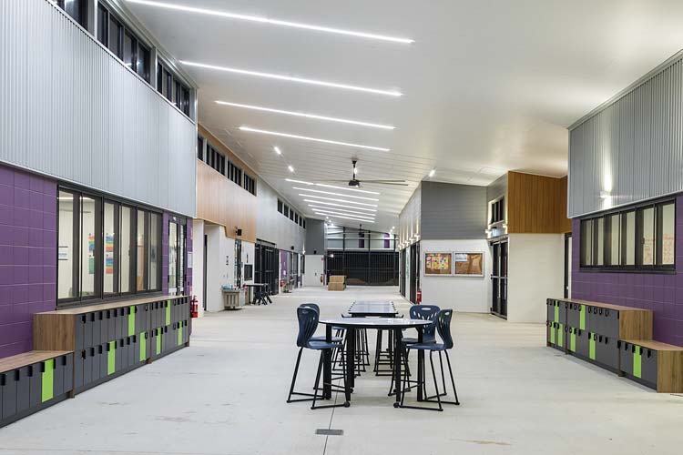 Interior of new school building showing central avenue with classrooms on both sides