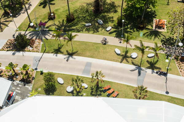 Aerial view of cyclist riding along path on Esplanade waterfront in Cairns